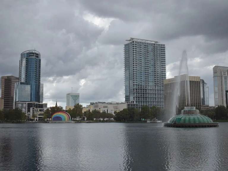 Lake Eola and its fountain in front of the downtown Orlando towers on a cloudy day
